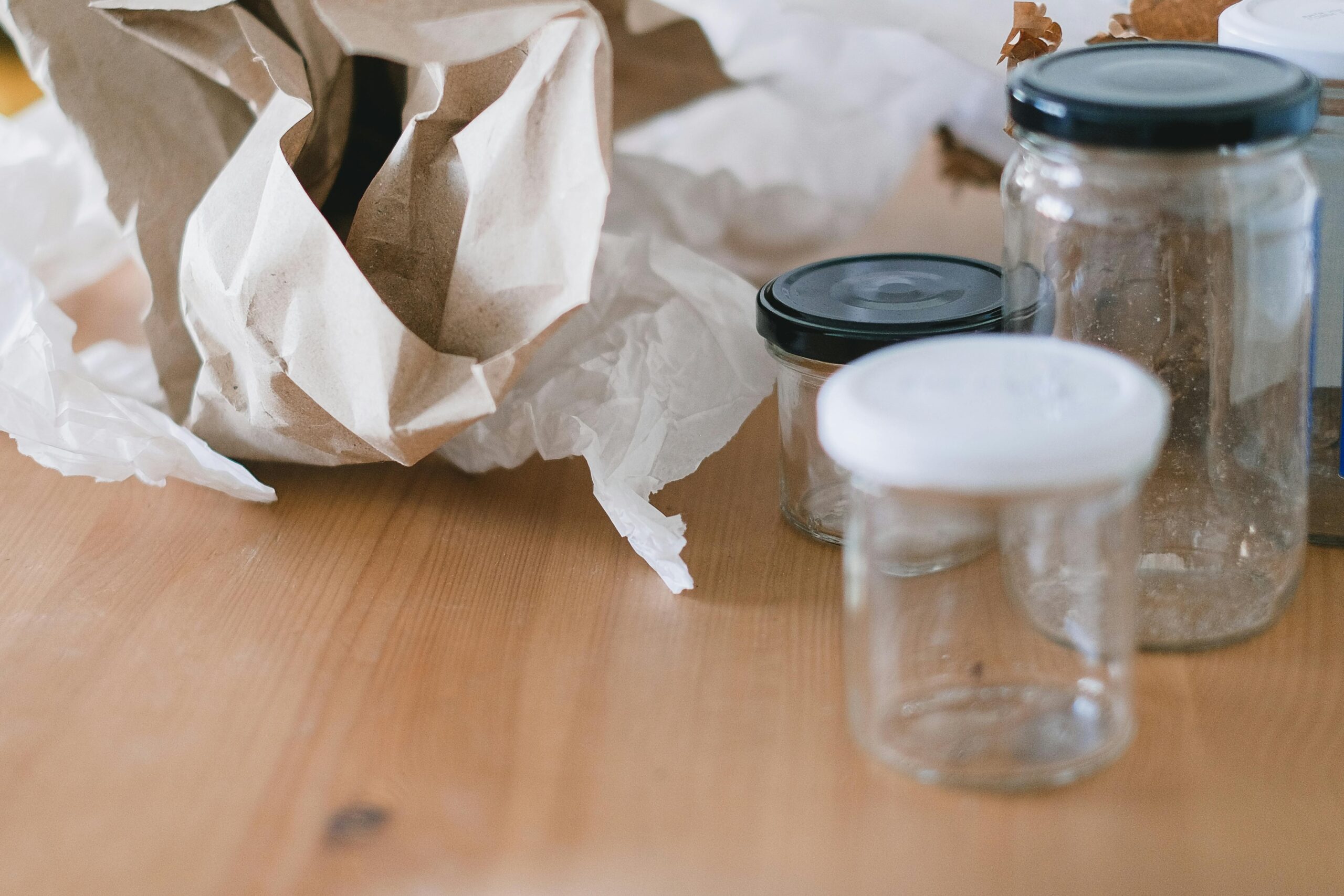 Glass jars and paper for eco-conscious waste sorting. Promote recycling and sustainability.