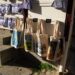 A vibrant display of canvas tote bags and lavender products in Arles, France.