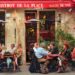 Outdoor seating at a bustling Parisian bistro, capturing lively conversation and vibrant atmosphere.